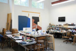 Jaramillo’s studio in Hampton Bays, New York, which is attached to her home, includes two workstations, filled with art supplies.